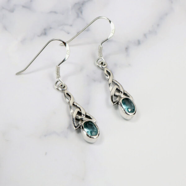 Triquetra Sterling Silver Earrings adorned with blue topaz stones will be replaced with "Triquetra Sterling Silver Earrings".