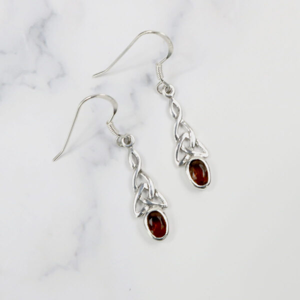 Triquetra Sterling Silver Earrings with a garnet stone.