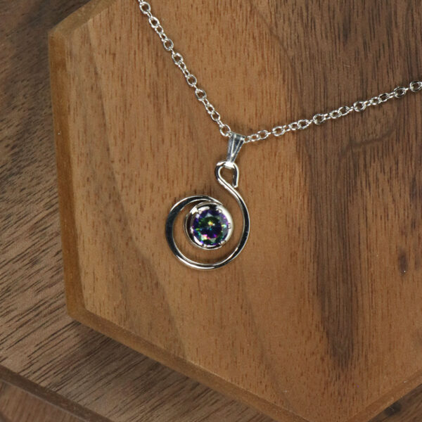 A silver spiral necklace with an Amethyst Celtic Knot stone, perfect for those who appreciate unique and elegant jewelry.