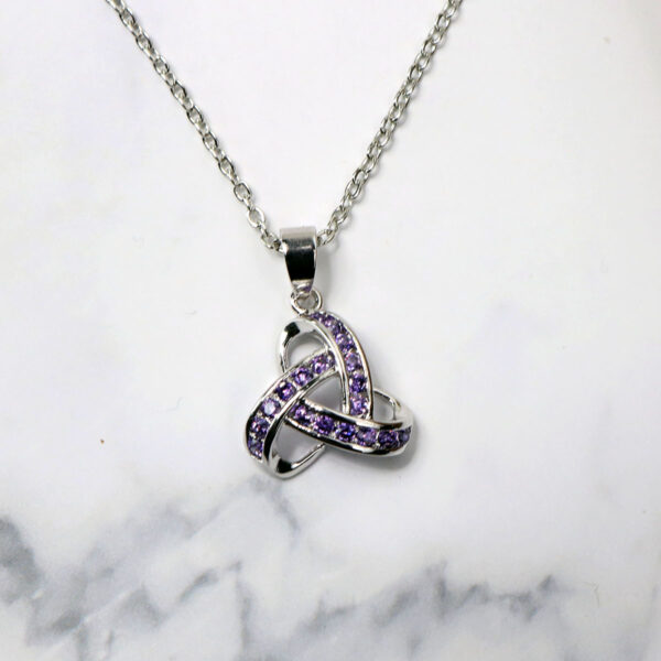 An Amethyst Celtic Knot Necklace adorned with amethyst crystals.