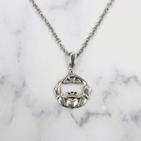 A silver claddagh necklace with a heart on it that complements the Triquetra Sterling Silver Earrings.