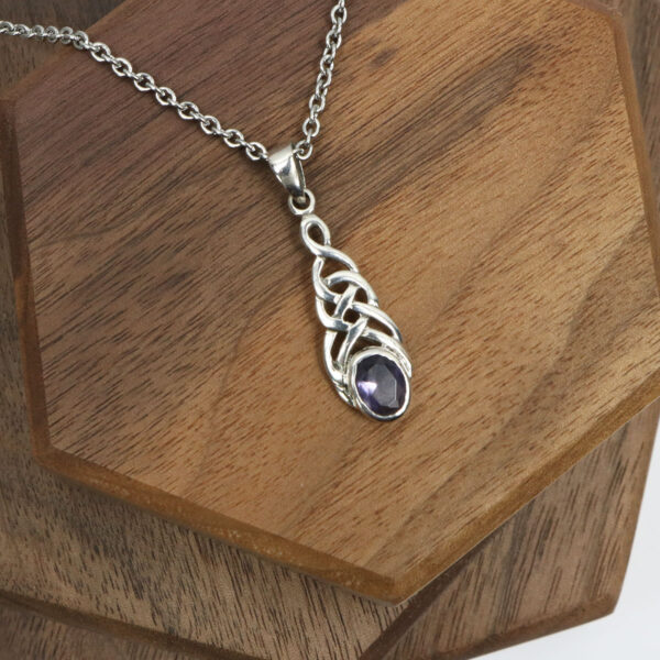 A sterling silver Amethyst Celtic Knot Necklace with a purple amethyst stone.