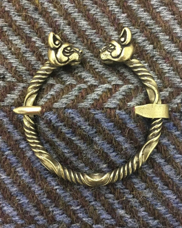 A bracelet with two wolf heads on it.
