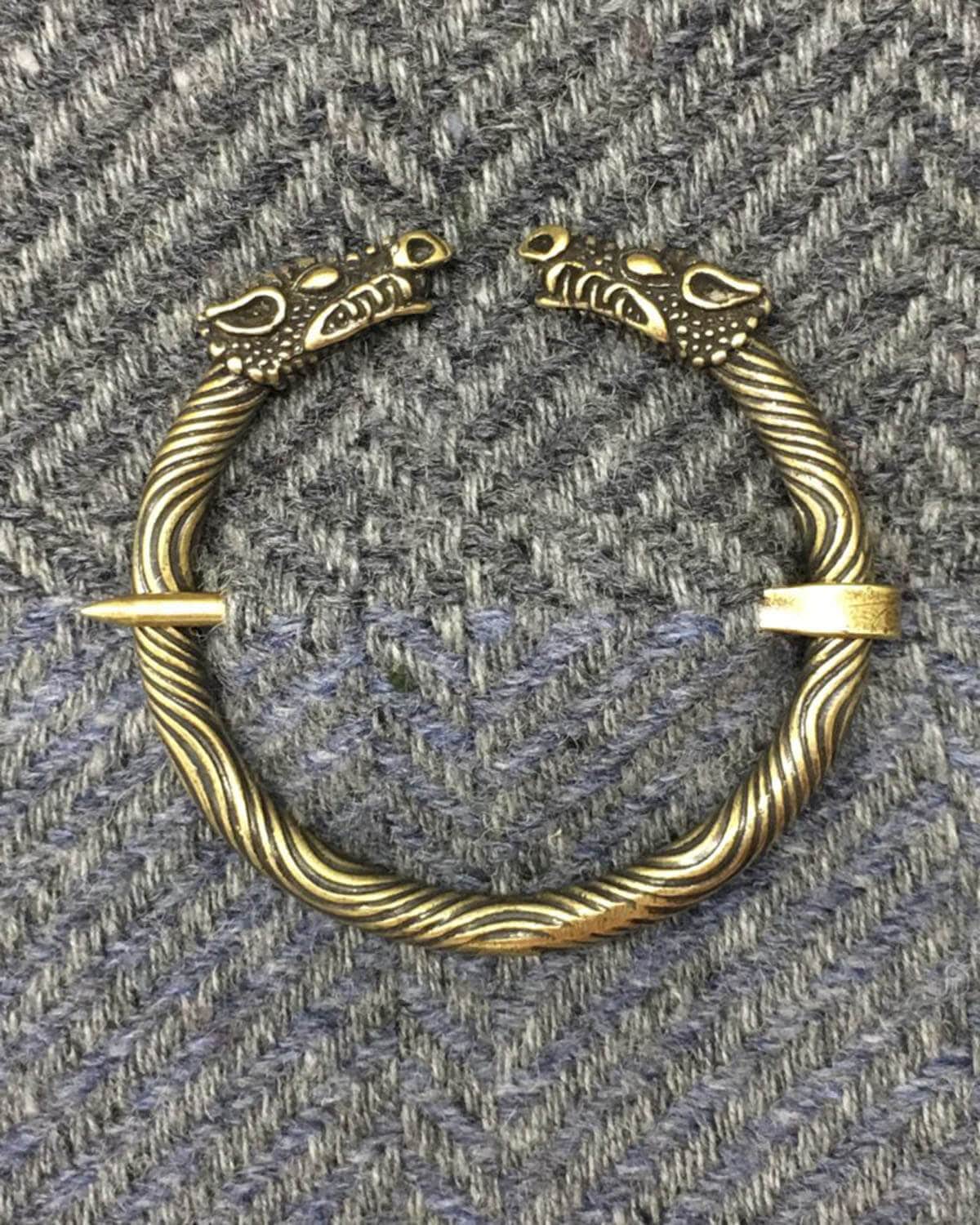 A bracelet with two dragon heads on it.