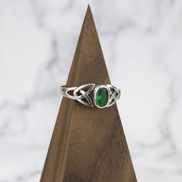 Elegant emerald ring featuring a Two Tone Eternity Knot Band in sterling silver.