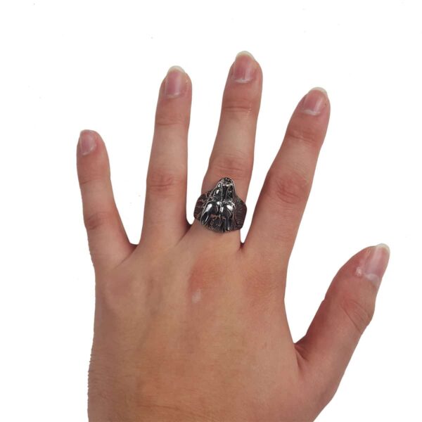 A woman's hand holding a Dire Wolf Stainless Steel Ring.
