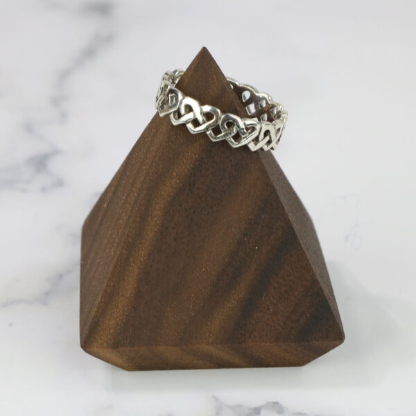 A wooden pyramid with a Large Celtic Knot Spinner Ring on top.
