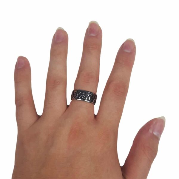 A woman's hand with a Two Tone Triquetra Ring on it.