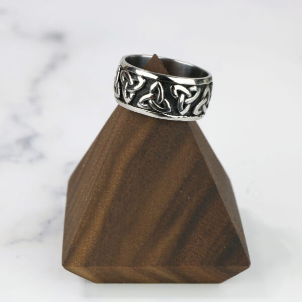 A **Two Tone Triquetra Ring** adorns the top of a wooden pyramid.