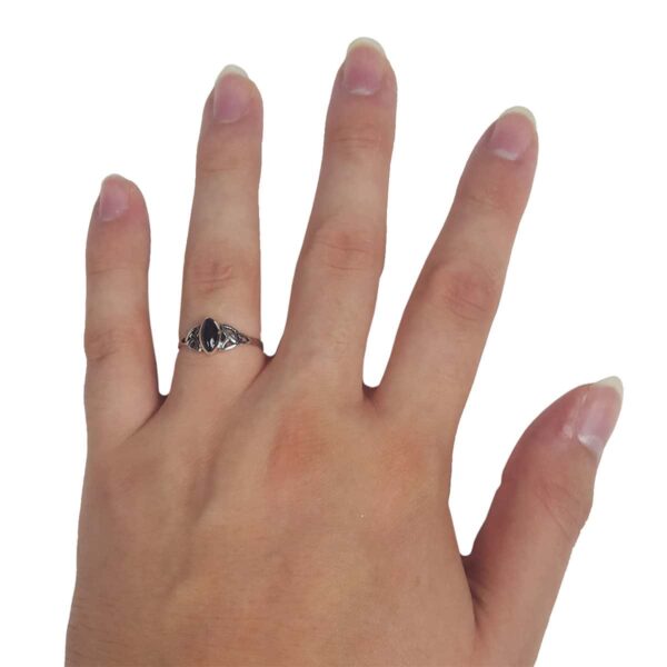 A woman's hand with an Onyx Triquetra Ring.