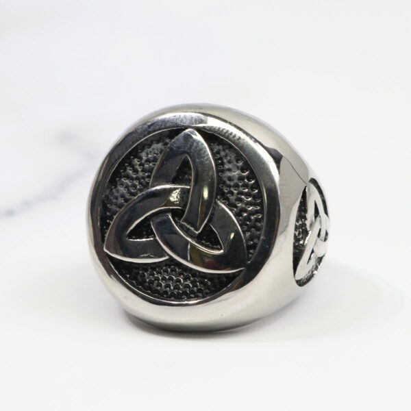 A Stainless Steel Triple Triquetra Ring with a celtic knot on it.