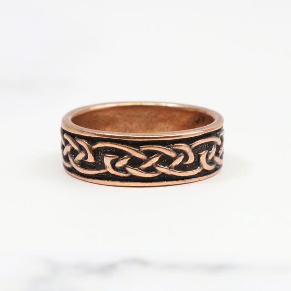 A Copper Celtic Knot Ring with a celtic knot design.