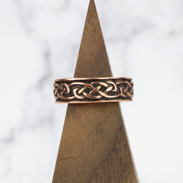 A Copper Celtic Knot Ring with a Celtic knot design.
