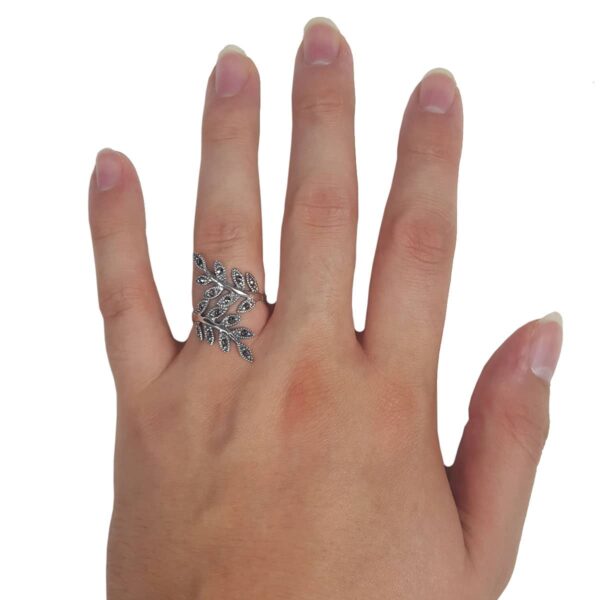 A woman's hand with a Sparkly Vines Sterling Silver Ring on it.