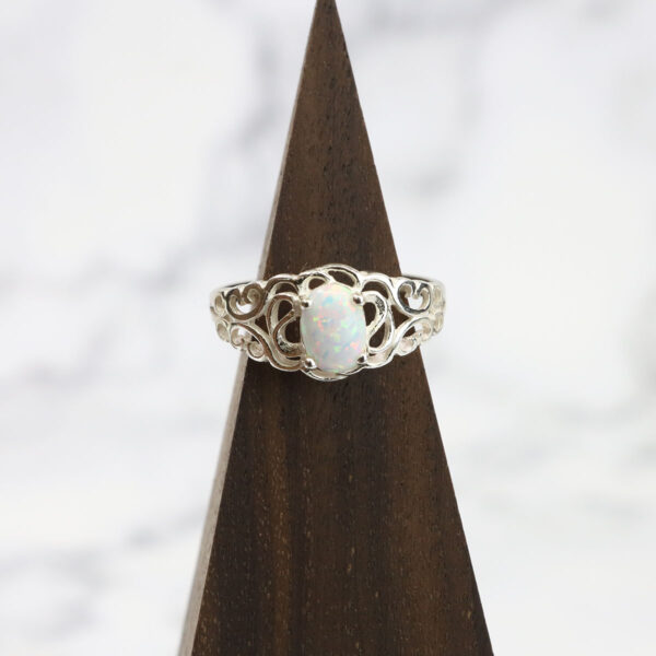 Filigree opal ring with a Two Tone Eternity Knot Band in sterling silver.