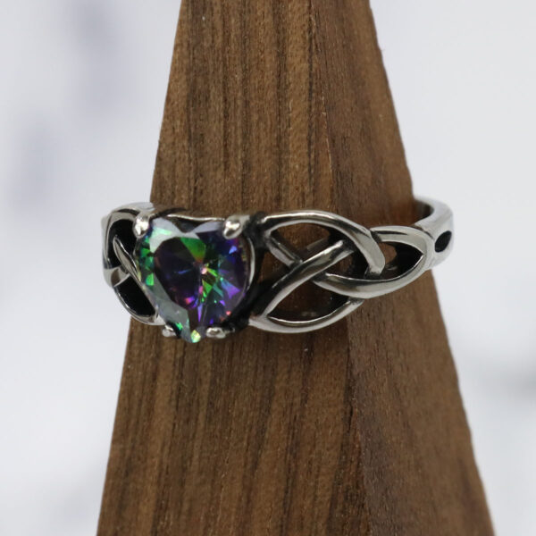 A Mystic Crystal Celtic Knot Heart Ring with an amethyst stone.