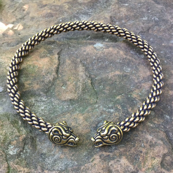 Two heavy braid bracelets adorned with a Celtic Bear Torc placed gently on a rock.
