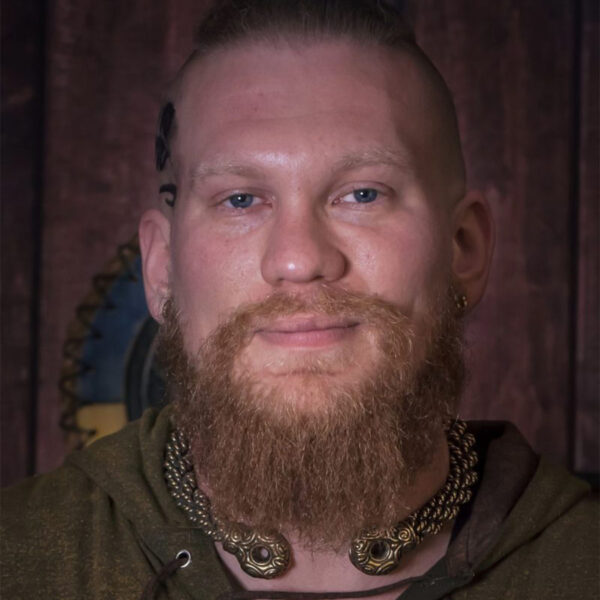 A man donning the Chieftains Torc Extra Heavy Braid, with a beard and chain necklace.