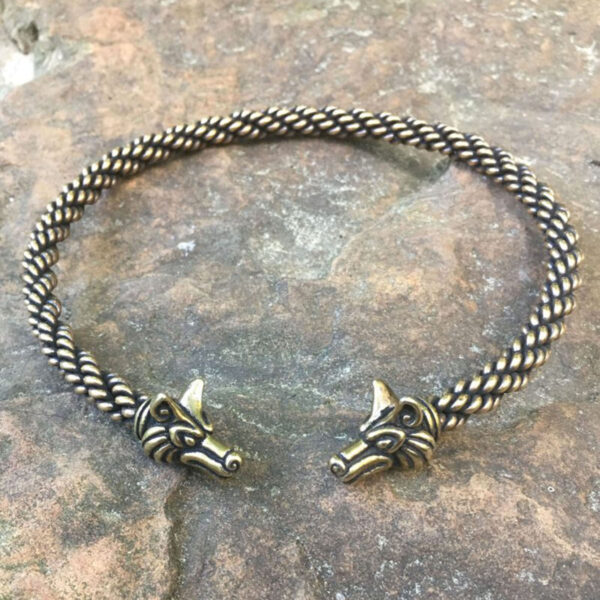 A Celtic Fox Torc - Medium Braid bracelet with two wolf heads on it.