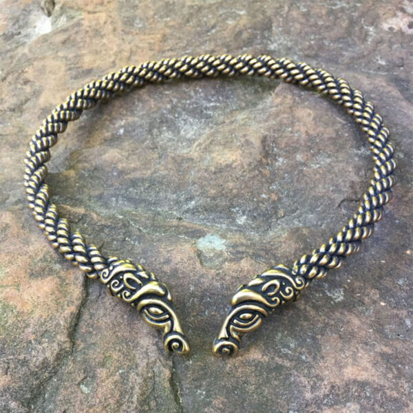 A braided necklace with two viking heads on it, styled in the shape of a Celtic Horse Neck Torc.