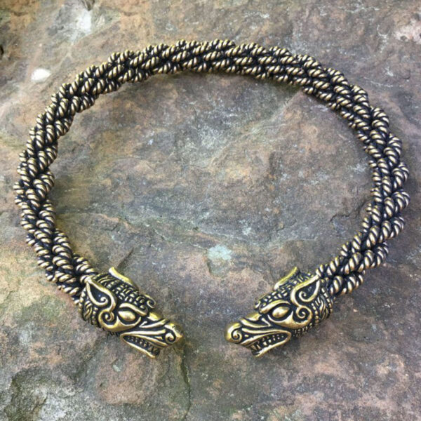 An Norse Wolf Torc Extra Heavy Braid bracelet with a Norse Wolf head on it.