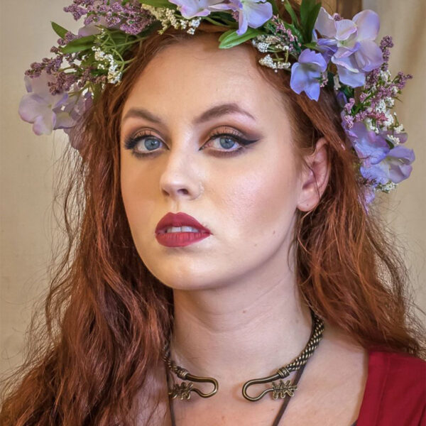A woman with red hair wearing an Oak Leaf Torc - Medium Braid flower crown.