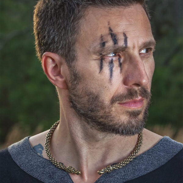 A man with a face tattooed using a Celtic Ram Torc - Medium Braid.
