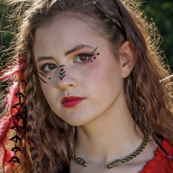 A girl in a red dress with feathers on her face resembling a Celtic Ram Torc - Medium Braid.