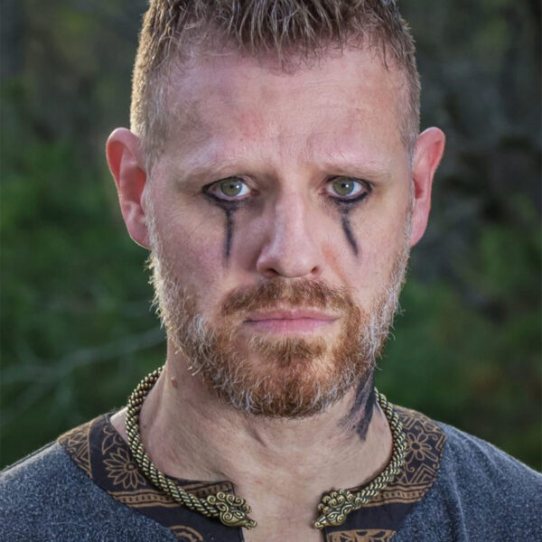 A man with viking tattoos, a beard, and a Celtic Stag Neck Torc.
