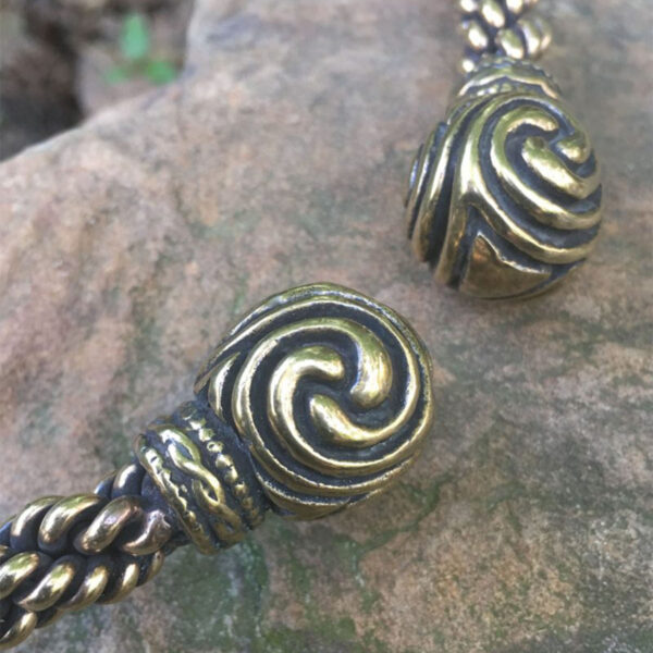 A Celtic Triskelion Neck Torc with intricate swirls reminiscent of a triskelion pattern.