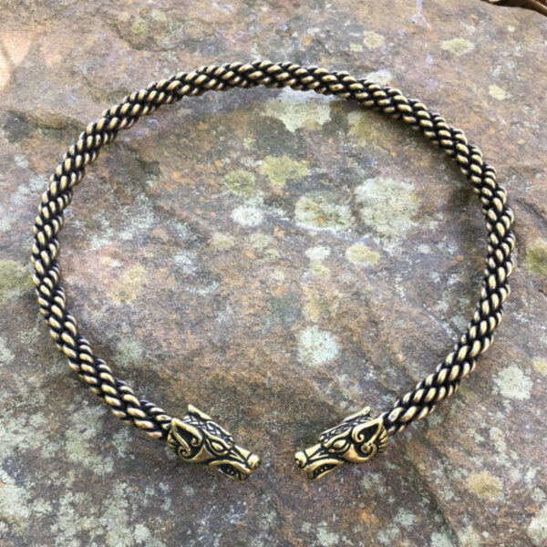 A braided Celtic Wolf Neck Torc with two Viking heads on it.
