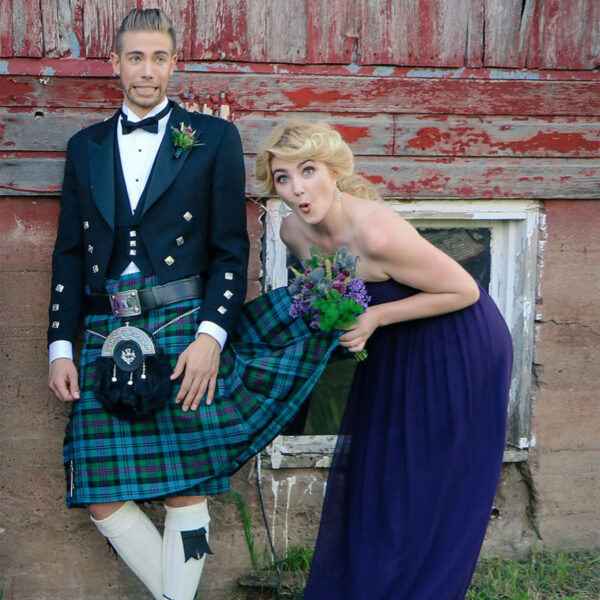 A man in a Prince Charlie Formal GOLD Package kilt and a woman in a dress.
