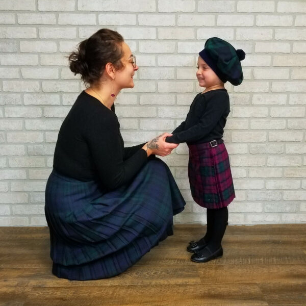 A woman in a kilt and a child in a kilt.