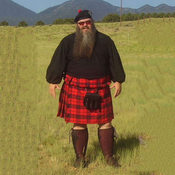 A man in a Heavy Weight 16oz Premium Wool Phillabeg standing in a field.