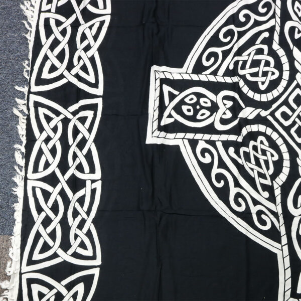 A Celtic Sarong Black and White Celtic Cross on the floor, perfect for Celtic enthusiasts.