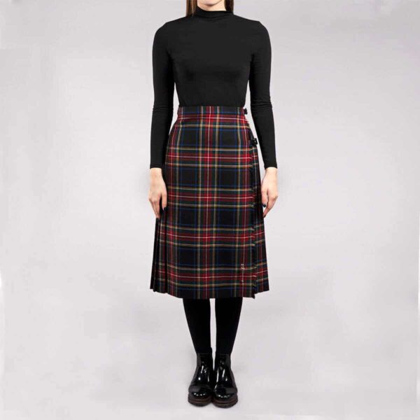 A woman wearing a black and red tartan skirt.