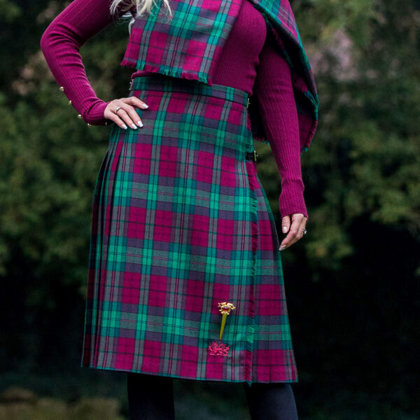 A woman in a Welsh Tartan Medium Weight Premium Wool Standard Ladies' Kilted Skirt posing for a picture.