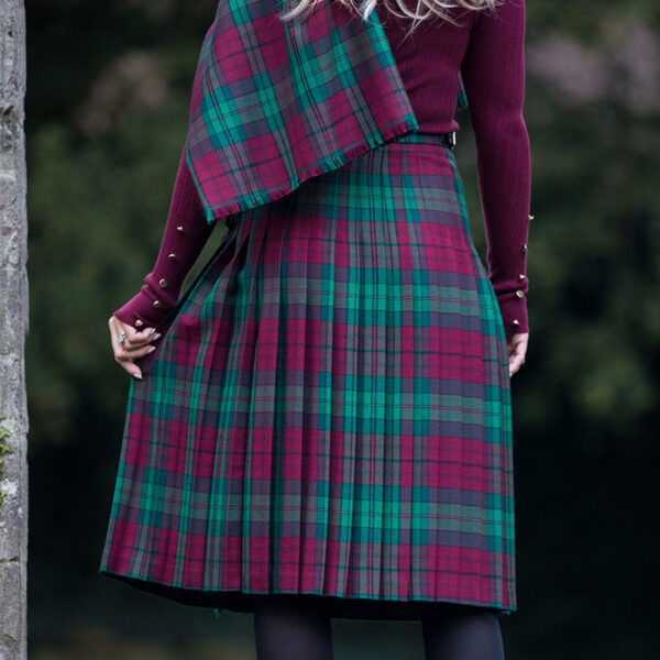 A woman wearing a Welsh Tartan Medium Weight Premium Wool Standard Ladies' Kilted Skirt.