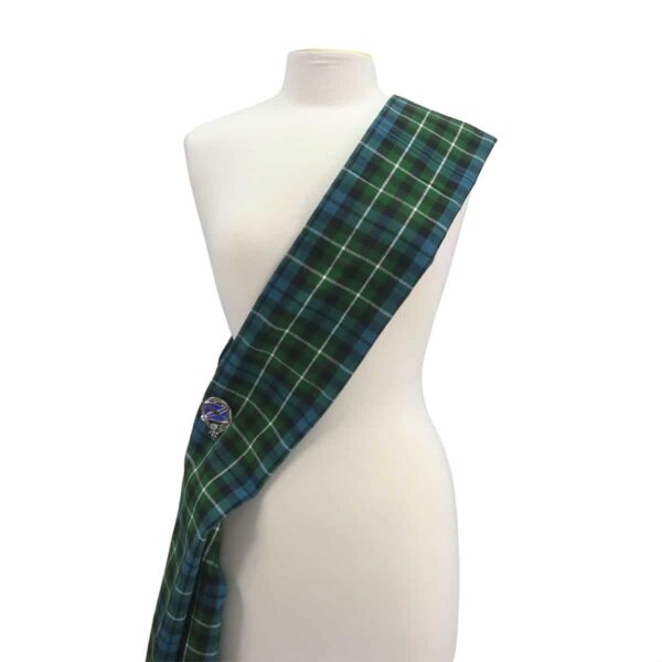 A green and blue tartan scarf on a mannequin.
