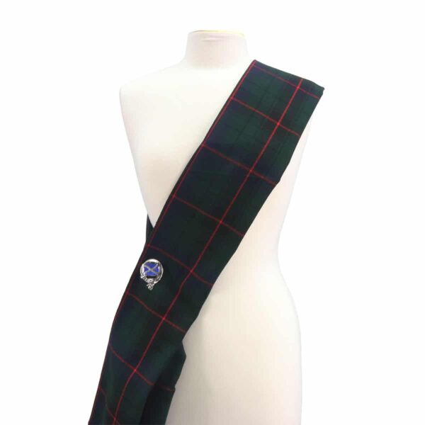 A mannequin with a green and red tartan sash.