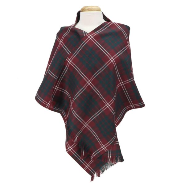 A red and green plaid poncho on a mannequin.