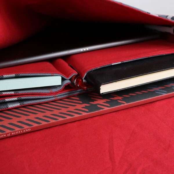 A laptop is sitting on top of a Tartan Folio - Poly/Viscose Wool Free.
