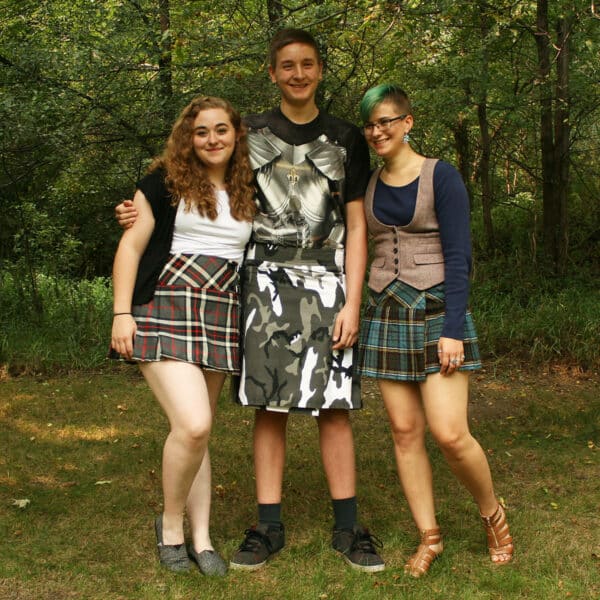A group of people in Premium Wool-Free Kid Kilts posing for a picture.
