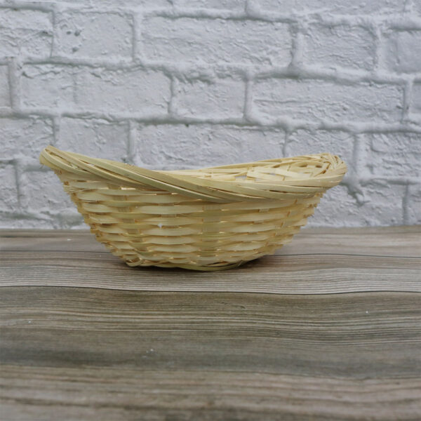 A small Bamboo Basket sitting on a wooden table.