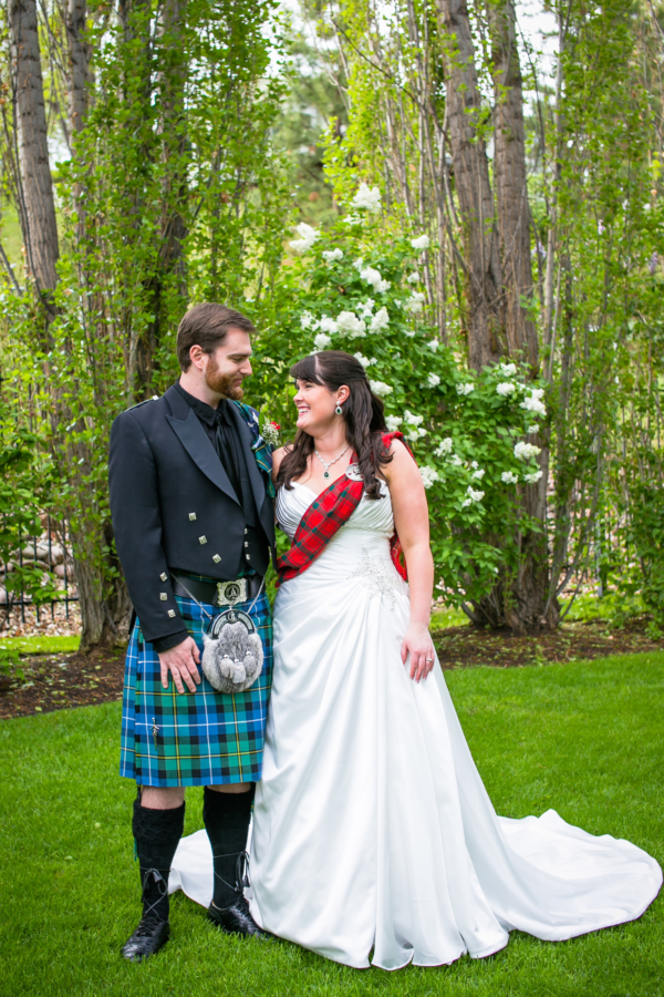 A bride and groom wearing kilts with a Light Weight Premium Wool Tartan Sash.