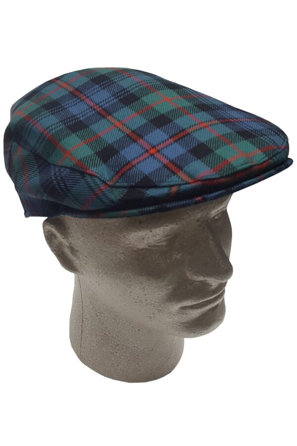 A mannequin wearing a scottish tartan flat cap.