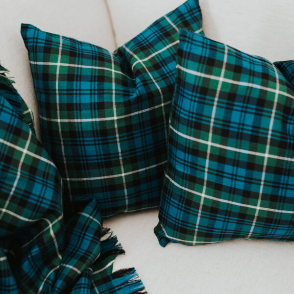 Two Homespun Tartan Blankets/Throws on a couch.
