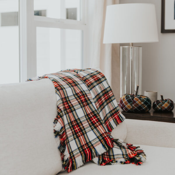 Homespun Tartan Blanket/Throw thrown on a couch in a living room.