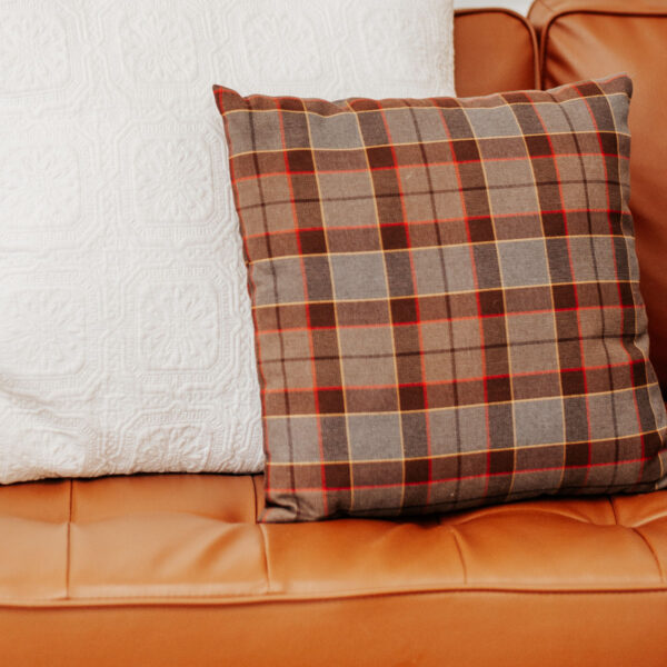 An OUTLANDER Throw Pillow Cover Authentic Premium Wool Tartan on a couch.