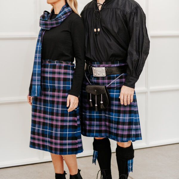 A man and woman in plaid kilts standing next to each other wearing Quality Wool Blend Kilts with Matching Tartan Flashes and FREE Kilt Hangers.